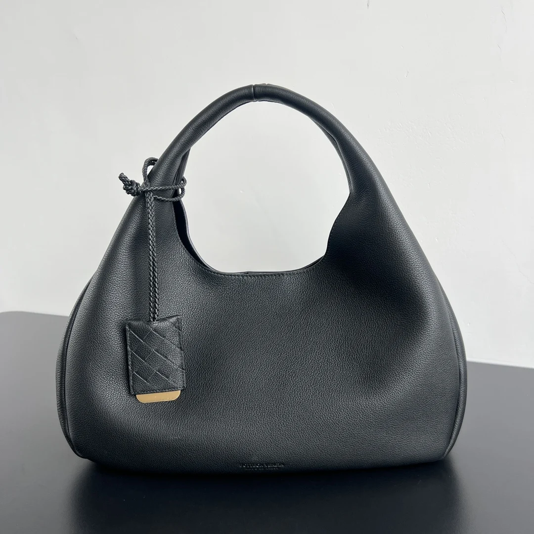 Bv新品 素面Campana 844251 绝对高级皮革 就像棉花糖一样 摸起来松松软软的感觉 采用荷兰小牛皮内里麂皮材质除了非常柔软之外 背起来超级轻盈的 附带编织零钱包 实用又有设计感 这款素面Campana更特别的是 配有小挂饰镜牌 上面还刻有品牌烙印 非常有质感 还可以当镜子使用 小编织挂饰和素面包包搭配 高级感真的无敌了 时髦又喜爱简约的都市女性必入 尺寸 39x24x18 5