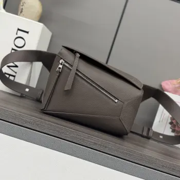 Lo w  新版本新款 小号经典粒面牛皮革 Puzzle 腰包*长方体形状和精确的切割技术创造了 Puzzle 独特的几何线条这款小号腰包采用经典粒面 牛皮革制成 饰有重叠边缘   肩背或斜挎*可调节肩带配有金属搭扣开合 刻有LOEW徽标*拉链开合 牛皮革拉链头*外部拉链口袋和内部插袋*一个外部拉链袋*人字纹棉质帆布衬里*Anagram 压纹size:24*16*10.5 型号 052344