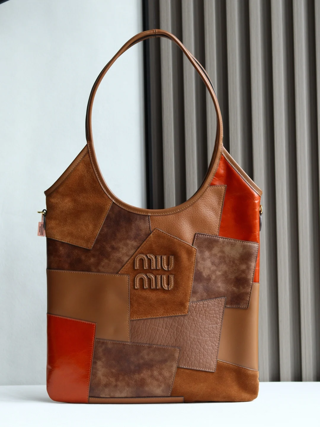 <p>Miu家新款伊势丹限定托特包重手工制作 多种皮质拼接而成 大胆创新的设计完美诠释了 Miu不拘一格 潇洒随意包容的人生态度 今年绝对爆 款式 顶级进口小牛皮 质感高级 包身软而不塌 气质随性慵懒 容量超大 日常出街背它回头率百分百 手工缝制皮面Logo标志 内里全新麻布里 配拉链式口袋 尺寸35 X 40Cm 型号 5BG231 配原版包装</p>