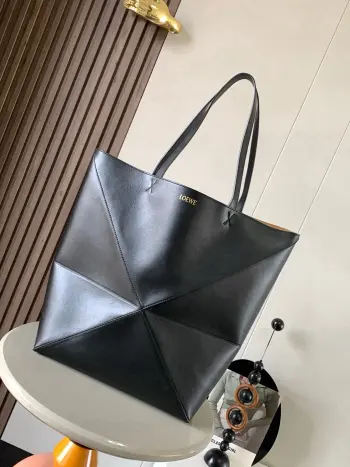 大号新款亮面牛皮革购物袋puzzle Fold手袋大号几何图形玩出花了  很久没见过这么实用又设计感满满的托特包了这款延续了Puzzle系列的几何美学以折纸包为灵感 让这只 Puzzle Fold tote 在立体和平面随意切换上身了两个尺码给大家参考哦大号容量更友好 小号很可爱 皮质都很细腻光泽本身自重超轻 能完全折叠是旅行良伴 这个大号版本采用柔软的亮面牛皮革打造尺寸 42CM 41CM 18CM款号 9033颜色 黑色