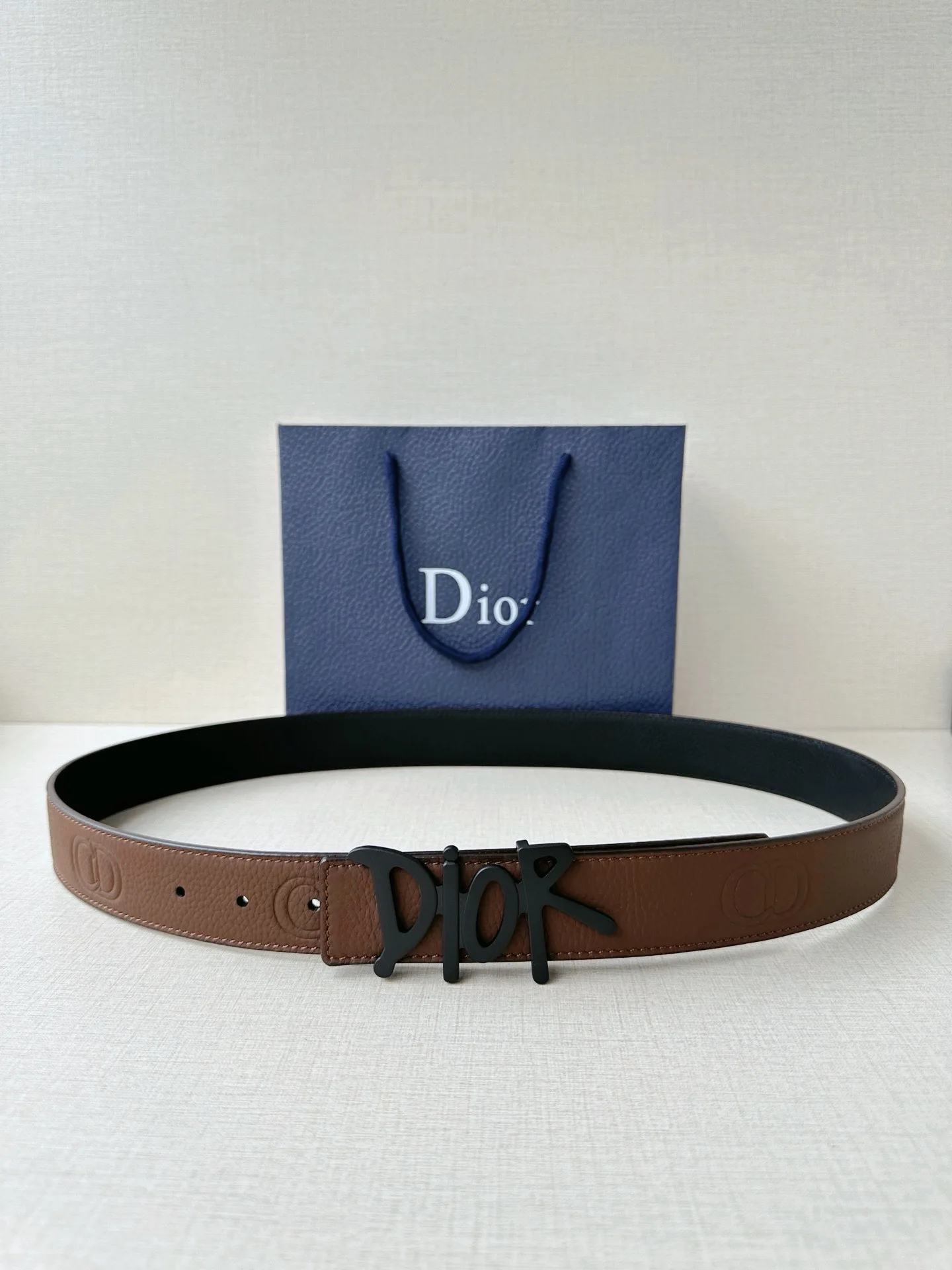 原单迪奥皮带|高仿迪奥皮带|精仿迪奥皮带|一比一迪奥皮带Dior 这款双面腰带结合典雅气质与摩登风范 双面均采用粒面牛皮革精心制作 一面为黑色 另一面多色可选 可搭配各式 35 毫米不锈钢腰带扣 更添精致 打造富有个性特色的配饰 时尚百搭 