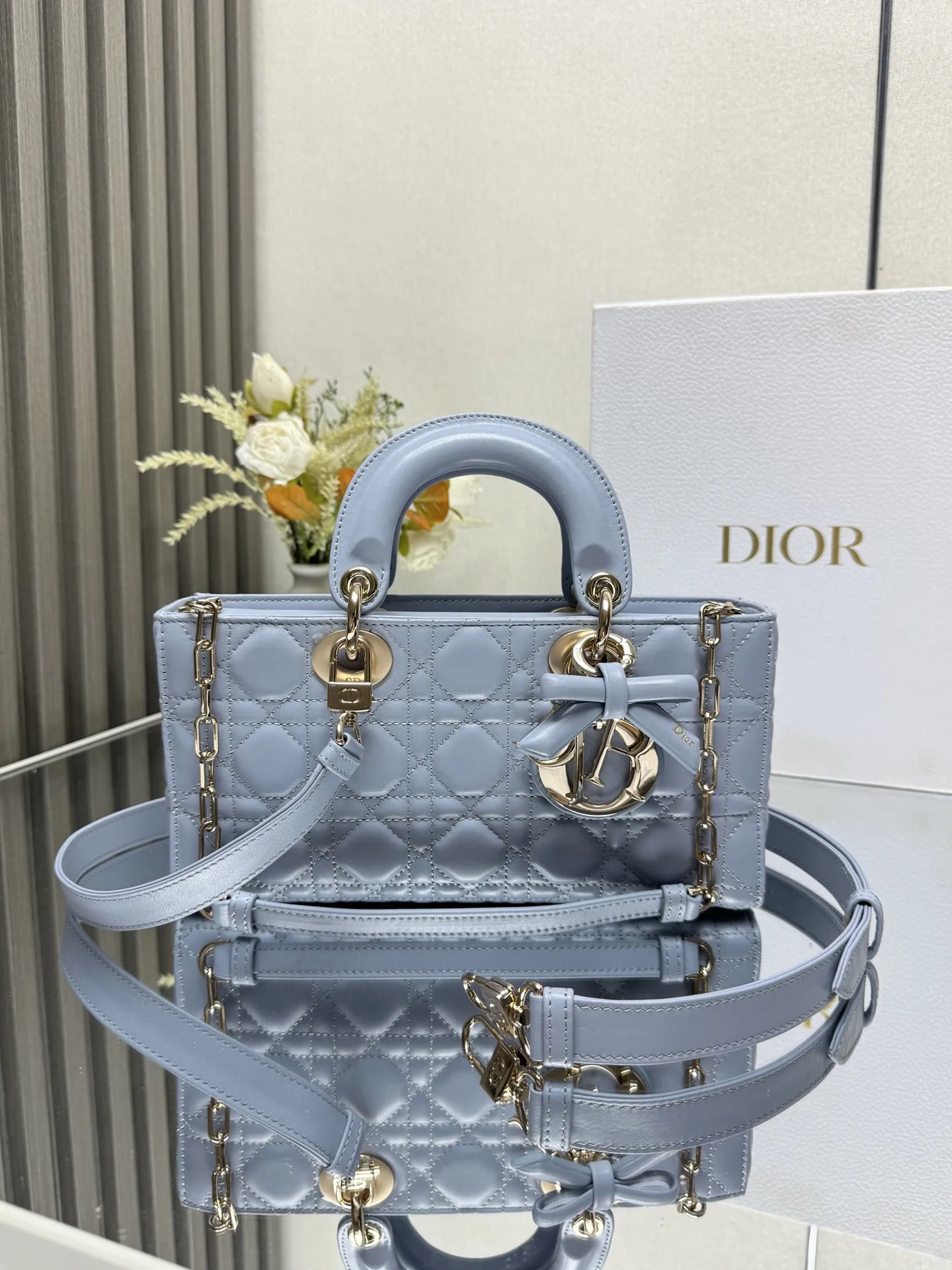 原单迪奥女包|高仿迪奥女包|精仿迪奥女包|一比一迪奥女包中号 LADY D-JOY 手袋 淡蓝色带蝴蝶结小羊皮 这款 Lady D-Joy 手袋凸显 Lady Dior 系列的简约美学 集中体现了 Dior 对典雅和美丽的深刻洞见 采用黑色哑光牛皮革精心制作 以经典的藤格纹缉面线打造醒目的绗缝细节 精良的缝制工艺显露无遗 同色调金属 D.I.O.R. 吊饰彰显优雅气质 小号款式 搭配可拆卸的链条肩带和可调节 可拆卸的皮革肩带 可手提 肩背或斜挎 是日常造型的理想之选 可拆卸链条肩带可拆卸 可调节的皮革肩带型号 0540尺寸 26×13.5×5 cm可收纳一部 iPhone和其他配饰238620
