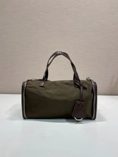 新品收纳包1TT348平纹2026秋冬系列时装秀中的层次造型,同样延伸至个性独特的皮具设计。这款迷你包采用创新可折叠廓形,以旅行袋造型呈现,随日常节奏自由变换。标志性Re-Nylon(再生尼龙)与小牛皮相结合,映射这款配饰的多元特质,于优雅与当代实用之间呈现平衡之美。长10x高11.5cm